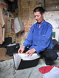 Han Hongbu has been petitioning the Chinese government to recover his confiscated farmland for four years. He shares his room with three other petitioners and faces eviction Wednesday.