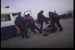 Plain-clothes police kick a Falun Gong practitioner in Tiananmen Square, Beijing as another is forced into a waiting police van in a clip from the upcoming CBC documentary Beyond the Red Wall: The Persecution of Falun Gong. (CBC)