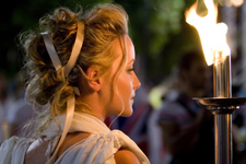 The Goddess of Justice makes her way through the crowd onto the stage at the Human Rights Torch Relay opening ceremony on the evening of August 9.