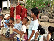 People queue to receive food at a monastery south of Rangoon on 1 June 2008