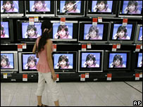 A woman looks at televisions on display in Wuhan, central China